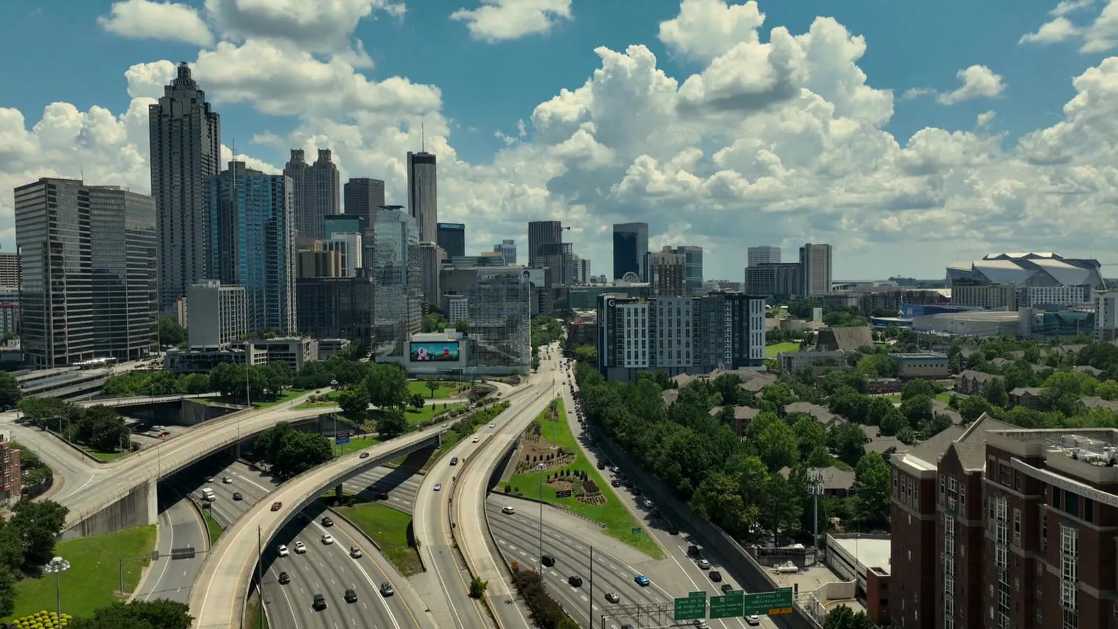 The downtown Atlanta skyline rising above the interstate connector on a clear day.